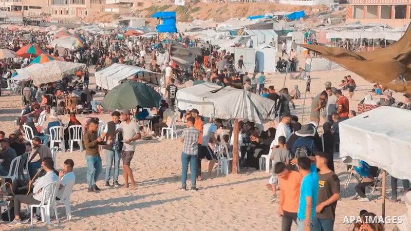 Restrictions Summary: APA wire clients only Shortlist: APAwire - APA wire clients only, Gaza- June 12, 2026. Palestinians spend time and swim at Gaza Beach in Gaza City, Gaza Strip, to escape high temperatures inside dis...