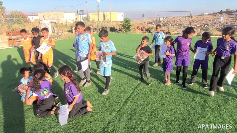 Restrictions Summary: APA wire clients only Shortlist: APAwire - APA wire clients only, Hebron - June 11, 2026. Children hold placards at a playground threatened with demolition in the village of Umm al-Khair, south of H...