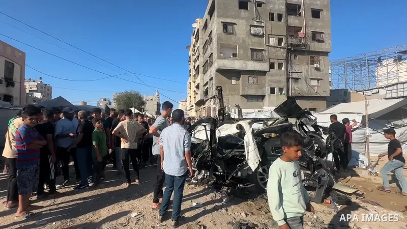 Restrictions Summary: APA wire clients only Shortlist: APAwire - APA wire clients only, Gaza- June 7, 2026. Palestinians gather at the site of an Israeli strike that targeted a vehicle near al-Lababidi Street in western...