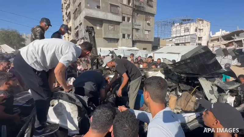 Restrictions Summary: APA wire clients only Shortlist: APAwire - APA wire clients only, Gaza- June 7, 2026. Palestinians gather at the site of an Israeli strike that targeted a vehicle near al-Lababidi Street in western...