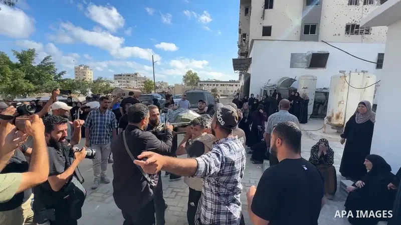 Restrictions Summary: APA wire clients only Shortlist: APAwire - APA wire clients only, Gaza- June 7, 2026. Mourners gather to bid farewell to the bodies of several Palestinians, including a child and his father, at al-S...