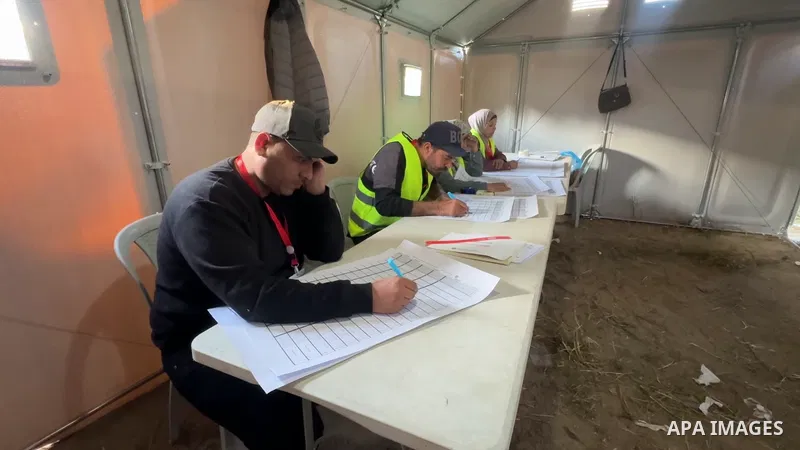 Restrictions Summary: APA wire clients only Shortlist: APAwire - APA wire clients only, Deir El-Balah- April 25, 2026. Palestinian election officials conduct the vote count inside a polling station for the municipal elec...
